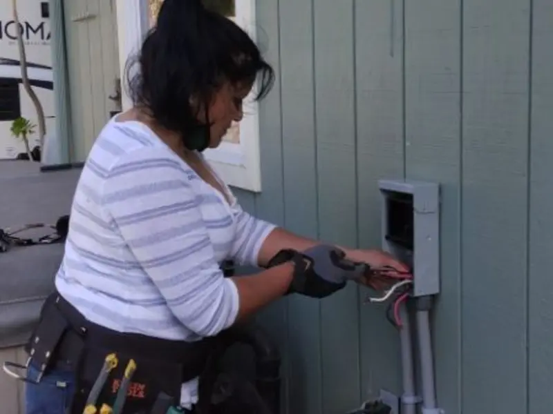 Licensed electrician wiring an exterior subpanel in Sandwich